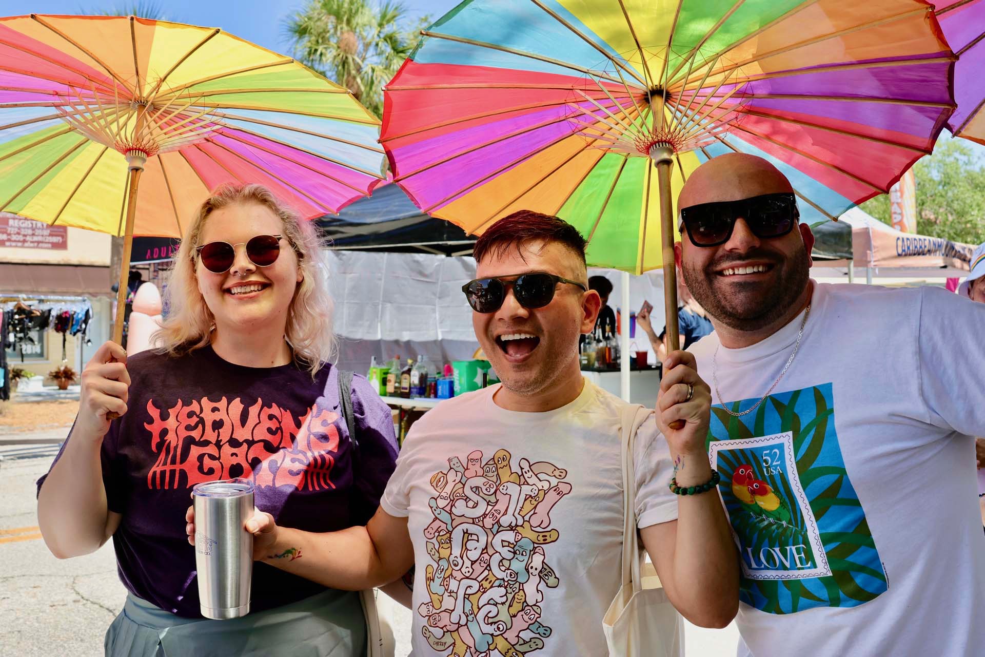 Friends with rainbow parasols at Gulfport Pride